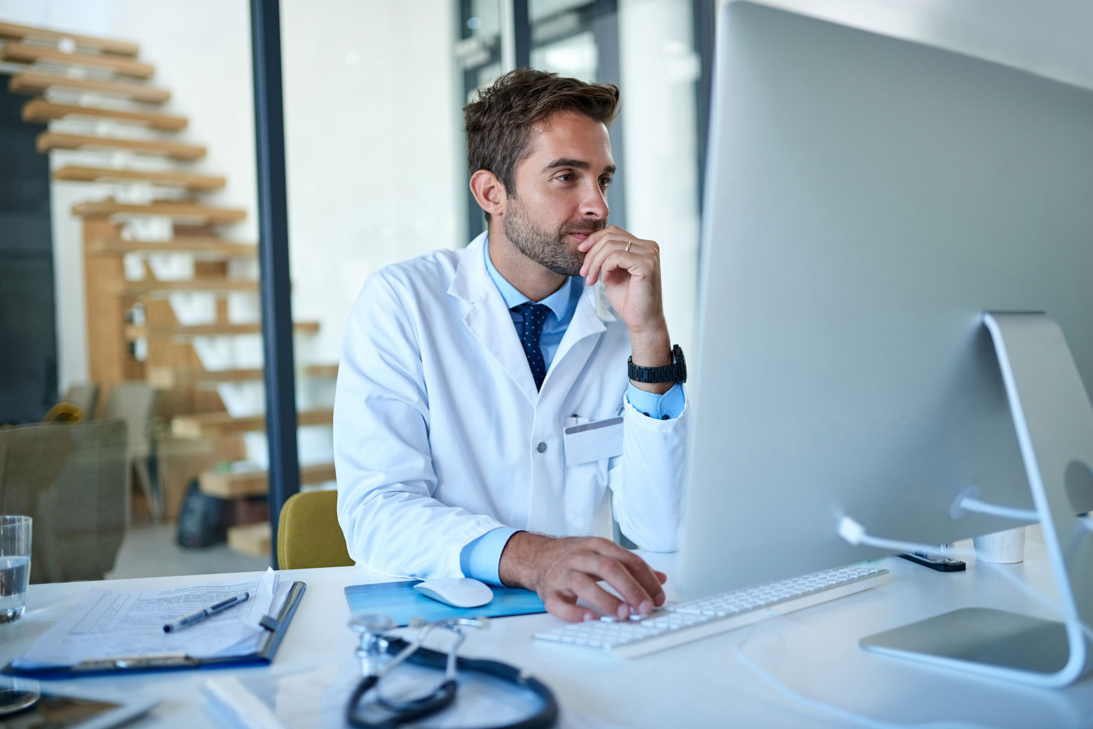 Doctor looking at computer screen.
