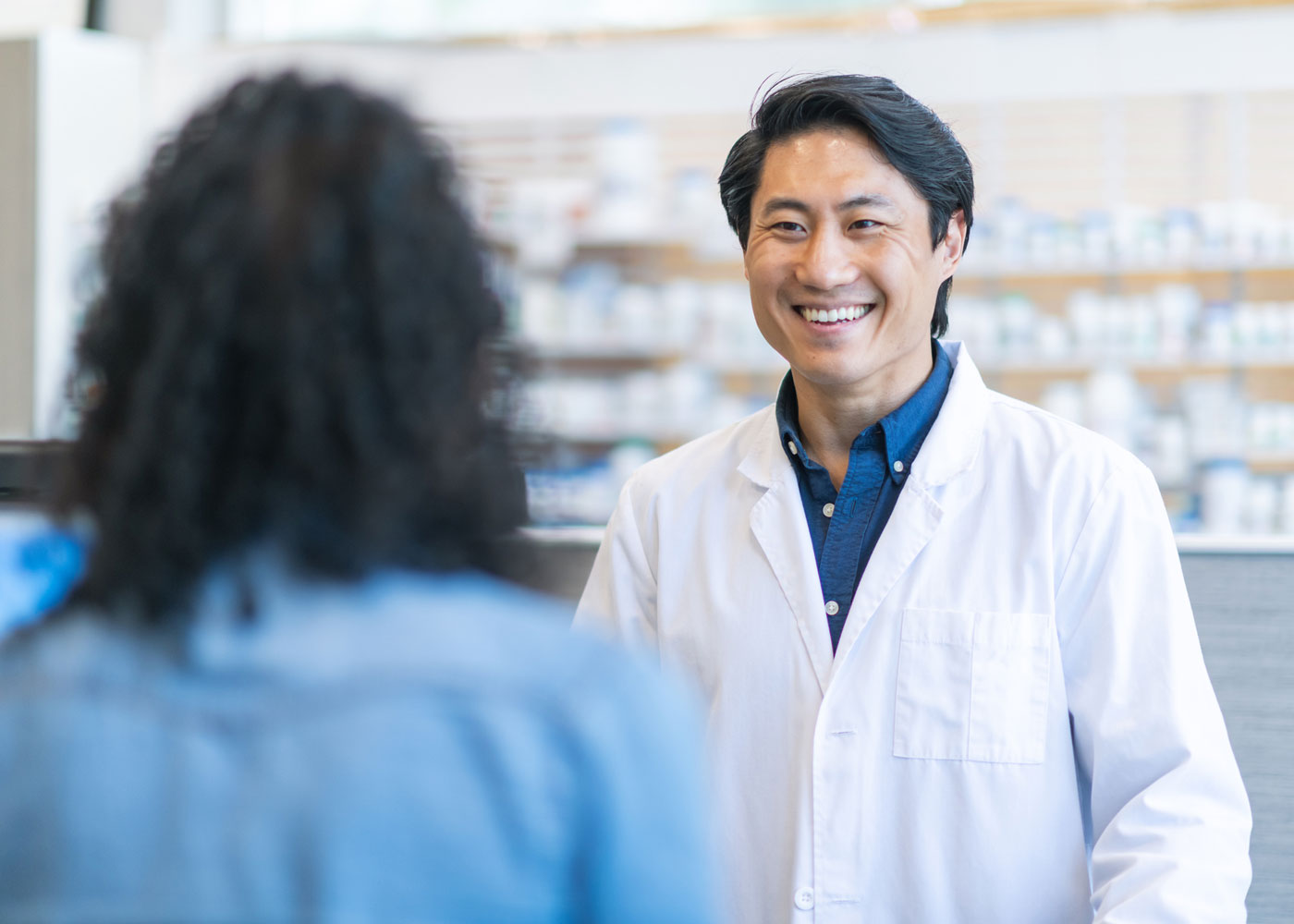 Pharmacist smiling at customer.