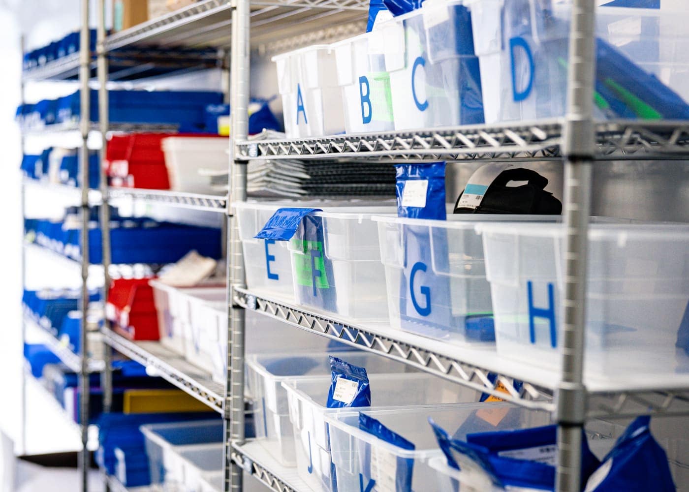 Labeled Storage Bins Organized On Metal Shelving System